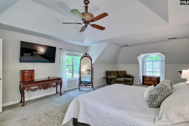 carpeted bedroom featuring a ceiling fan, baseboards, visible vents, and lofted ceiling