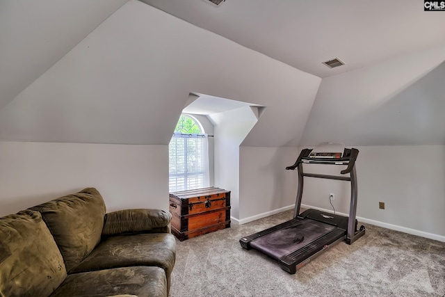 exercise area with baseboards, carpet flooring, vaulted ceiling, and visible vents