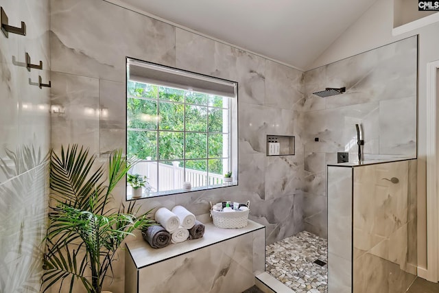 bathroom featuring plenty of natural light, a walk in shower, and lofted ceiling