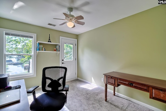 carpeted office featuring visible vents, plenty of natural light, ceiling fan, and baseboards