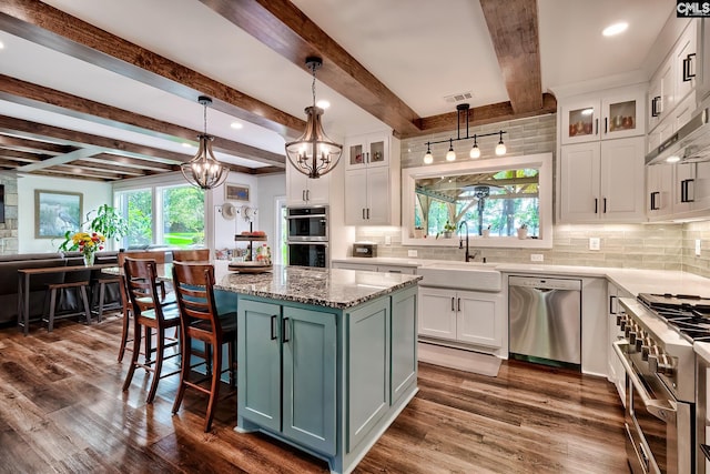 kitchen with visible vents, a sink, appliances with stainless steel finishes, and white cabinets