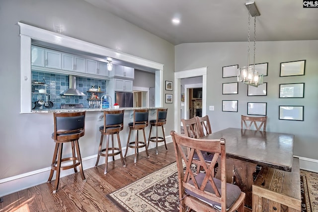 215 Greenbrier Mossydale Rd, Winnsboro, SC 29180 - dining room featuring baseboards, lofted ceiling, a chandelier, and dark wood-type flooring