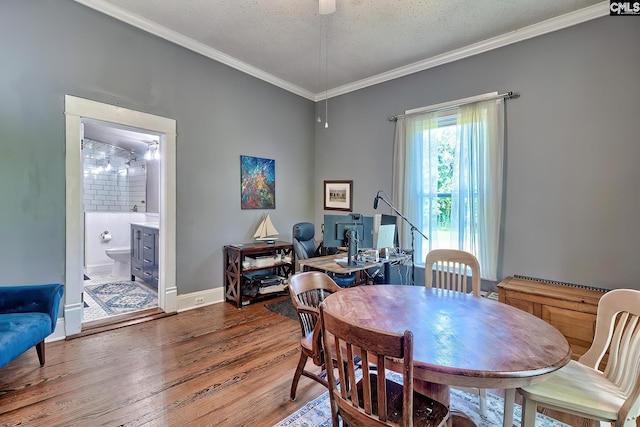 215 Greenbrier Mossydale Rd, Winnsboro, SC 29180 - dining space featuring crown molding, baseboards, a textured ceiling, and wood finished floors