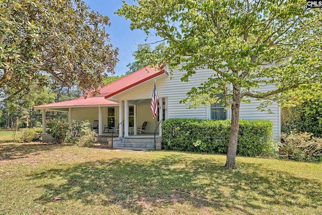 215 Greenbrier Mossydale Rd, Winnsboro, SC 29180 - view of front of home featuring covered porch, a front yard, and metal roof