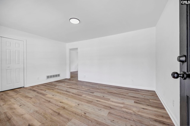 interior space with visible vents, baseboards, and wood finished floors