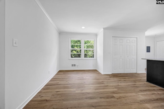 unfurnished living room with crown molding, visible vents, wood finished floors, baseboards, and recessed lighting