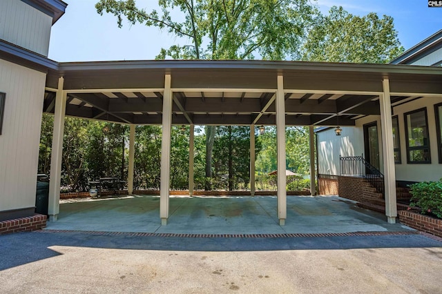view of patio featuring aphalt driveway and a carport