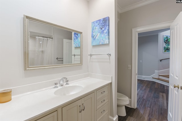 full bathroom featuring crown molding, wood finished floors, toilet, and vanity