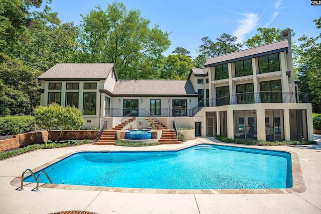 outdoor pool featuring an in ground hot tub, french doors, and stairway