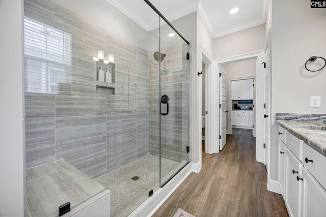 2358 High Bluff Loop, Lexington, SC 29072 - bathroom featuring vanity, ornamental molding, wood finished floors, and a shower stall