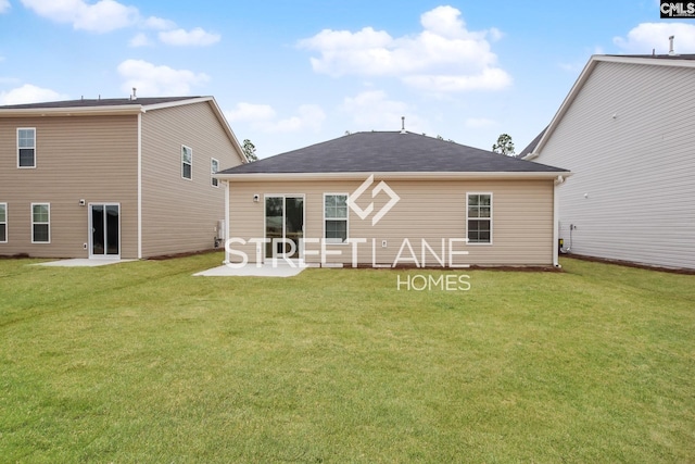 rear view of house with a yard and a patio area