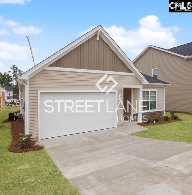 view of front of home with cooling unit, a front yard, driveway, and a garage