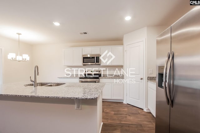 kitchen featuring a sink, visible vents, dark wood finished floors, white cabinets, and appliances with stainless steel finishes