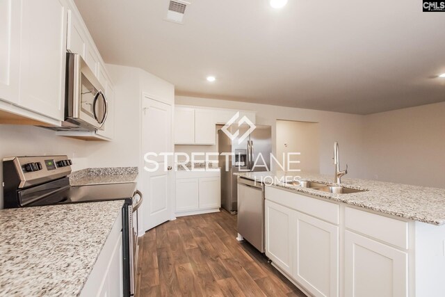 kitchen featuring a sink, stainless steel appliances, visible vents, dark wood finished floors, and white cabinetry