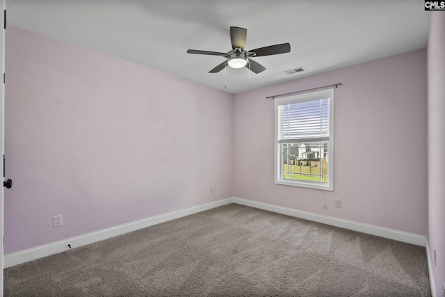 spare room with baseboards, a ceiling fan, carpet flooring, and visible vents