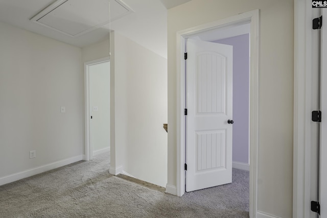 interior space featuring baseboards, carpet, and attic access