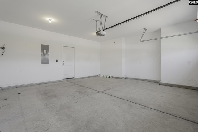 garage featuring baseboards, a garage door opener, and electric panel