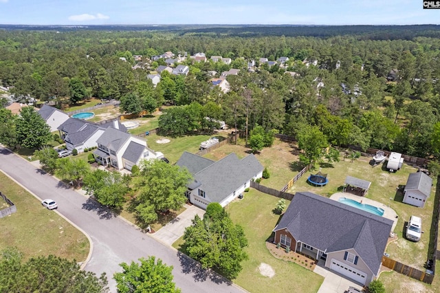 drone / aerial view with a view of trees and a residential view