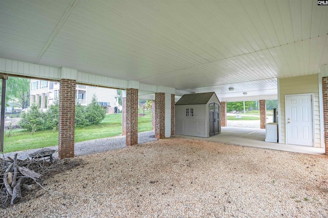 view of patio / terrace with a storage shed and an outbuilding