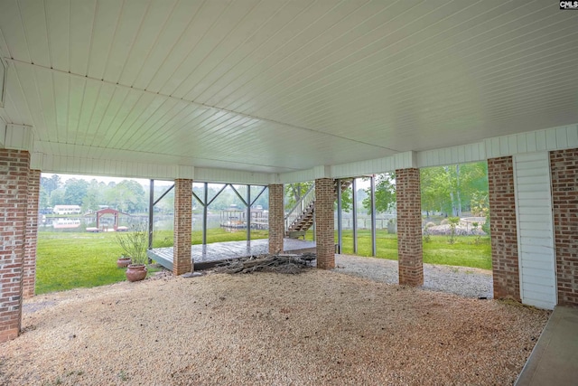 view of patio with fence, stairway, and a carport