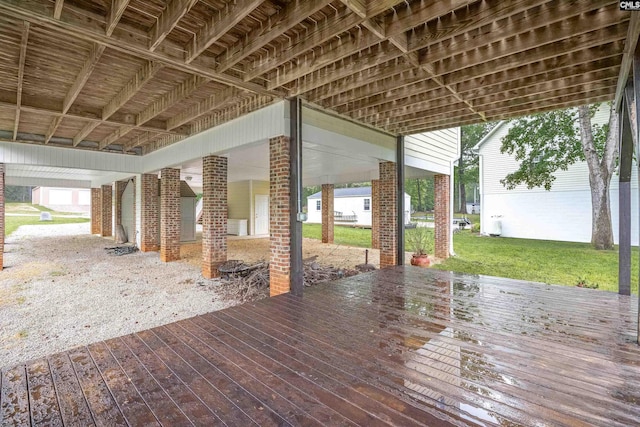 wooden deck featuring a lawn