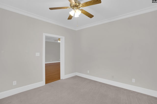 unfurnished room with crown molding, a ceiling fan, carpet, and baseboards