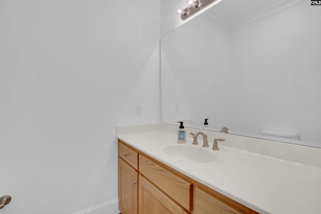 bathroom with vanity and ornamental molding