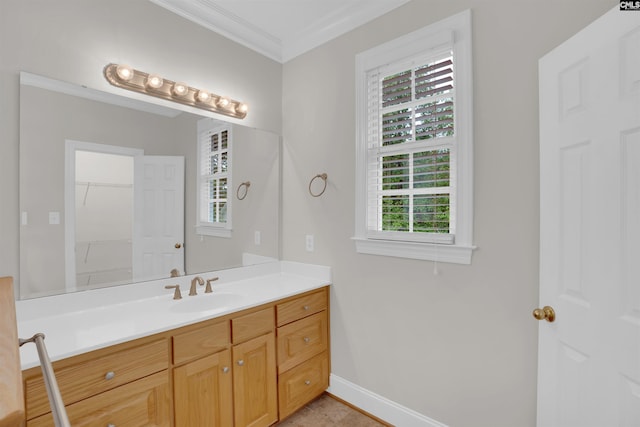 bathroom with crown molding, vanity, baseboards, and a wealth of natural light