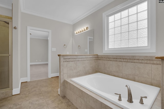bathroom with tile patterned flooring, ornamental molding, a shower stall, and a bath