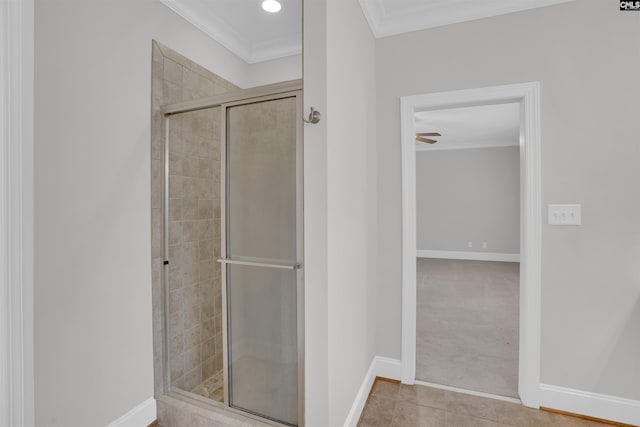 full bath with crown molding, baseboards, a shower stall, and tile patterned flooring