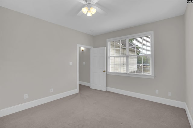 unfurnished room featuring ceiling fan, baseboards, and carpet