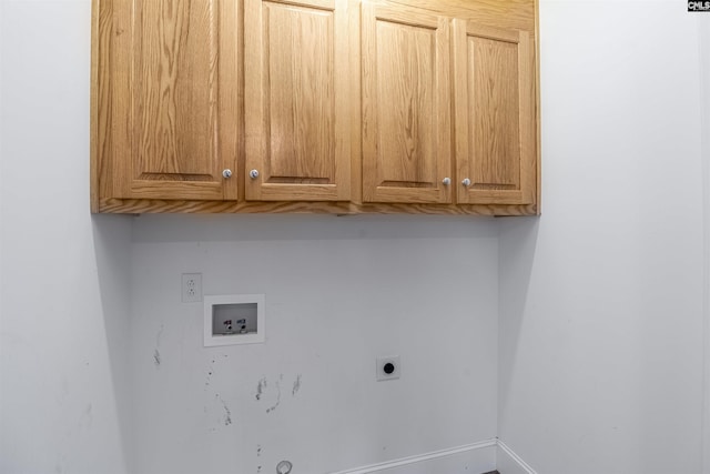 washroom with baseboards, hookup for a washing machine, electric dryer hookup, and cabinet space