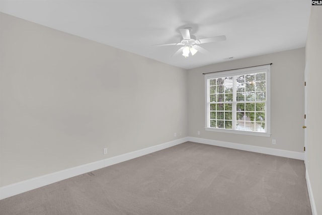 carpeted empty room with baseboards and ceiling fan