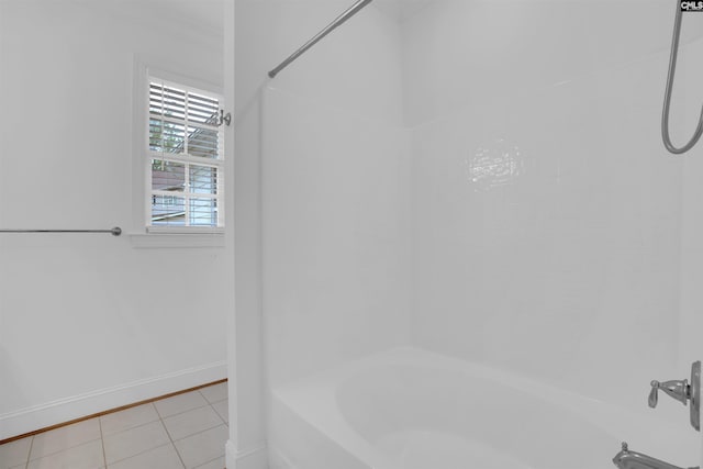 bathroom with baseboards, tile patterned floors, and bathtub / shower combination