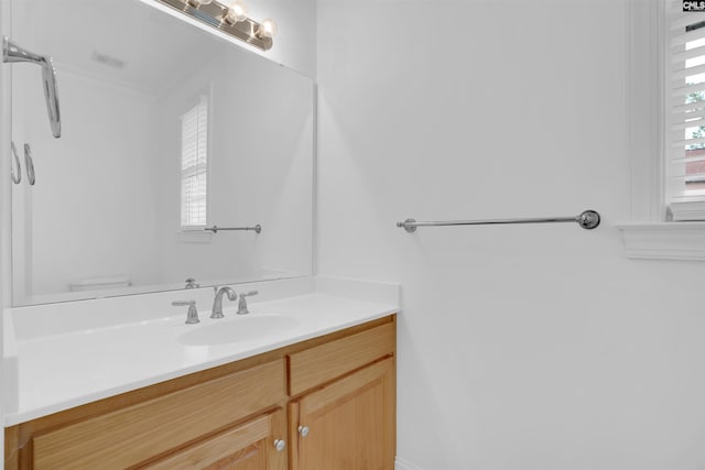 bathroom with vanity, toilet, and visible vents