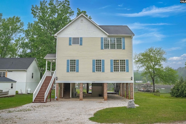 view of front of property featuring a carport, driveway, stairway, and a front yard