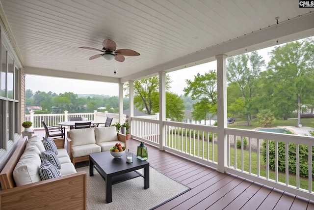 wooden deck featuring outdoor dining area, outdoor lounge area, and ceiling fan