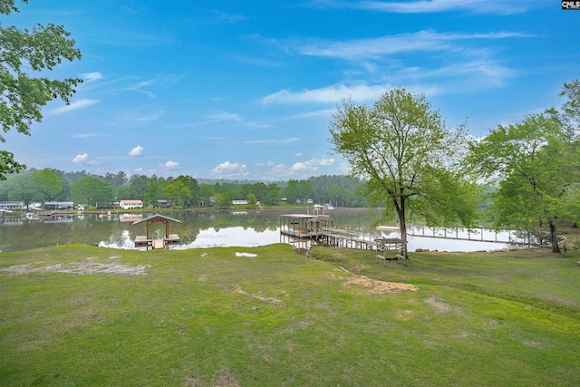 view of yard featuring a water view and a dock