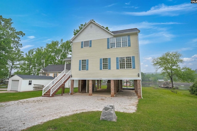 raised beach house featuring a front yard, driveway, an outbuilding, stairway, and a carport
