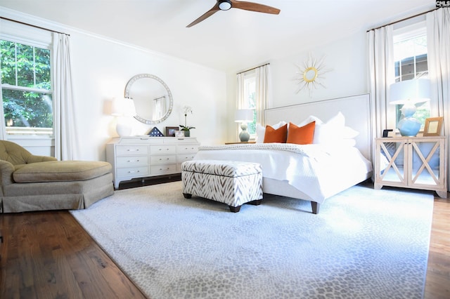 bedroom featuring crown molding, a ceiling fan, and wood finished floors