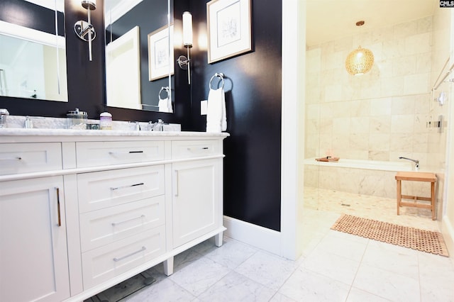full bathroom featuring baseboards, double vanity, marble finish floor, and tiled tub