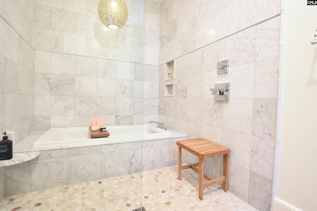bathroom with tiled bath and tile walls