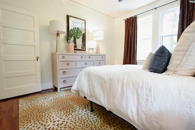 bedroom with baseboards and wood finished floors