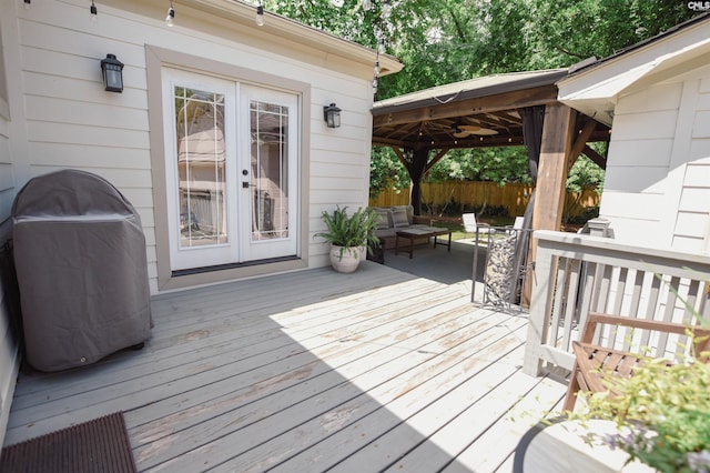 deck featuring a gazebo, outdoor lounge area, french doors, and grilling area
