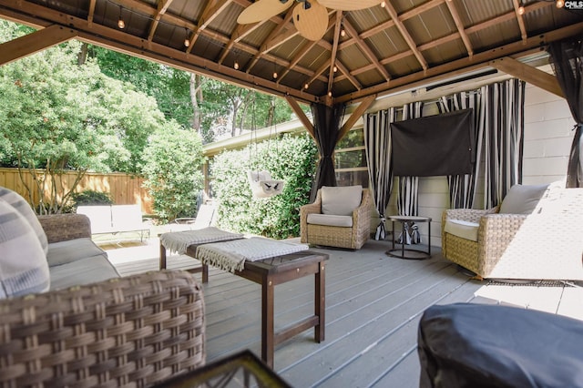 wooden deck with a gazebo, ceiling fan, and fence