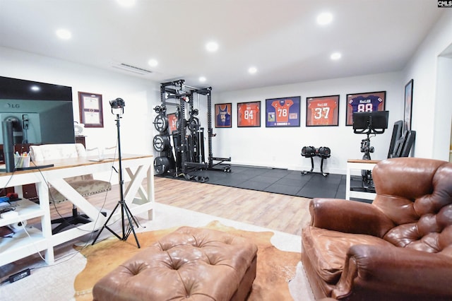exercise room with recessed lighting, visible vents, and wood finished floors