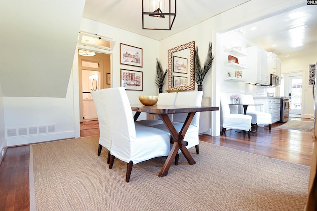 dining room with baseboards, wood finished floors, and visible vents