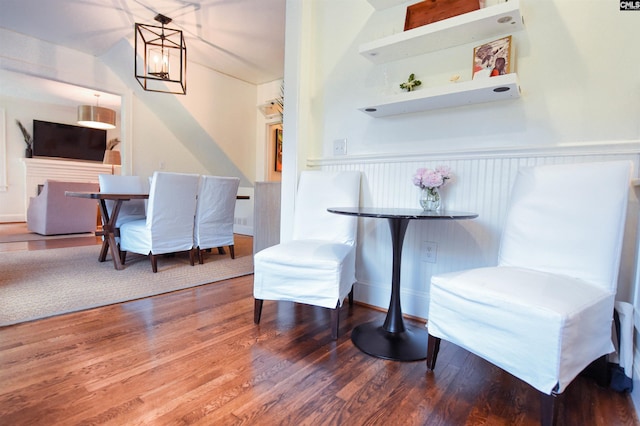 dining room with a wainscoted wall and wood finished floors