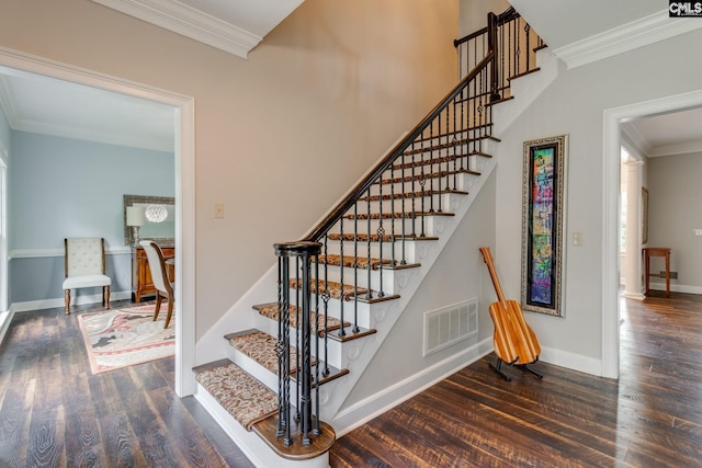 stairway with crown molding, baseboards, wood finished floors, and visible vents