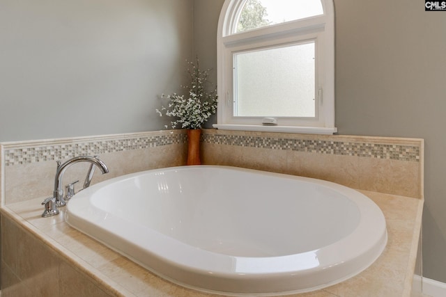 bathroom with a relaxing tiled tub